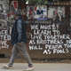 A man walks past a gate with a peace message painted by local street artist Solomon Muyundo, also known as Solo7, in Kibera slum, Nairobi, Kenya, 13 August 2017. After three days of running battles between stone throwing supporters and riot police, Kenyan opposition leader Raila Odinga told the assembled masses, 13 August, that he believed that the election had been stolen from them, that the government was using the police to kill his supporters, and that nobody should go to work. Odinga's Chief Agent James Orengo also told crowds that elements of the media were biased and prejudiced against them. Kenya general elections results aftermath, Nairobi - 13 Aug 2017